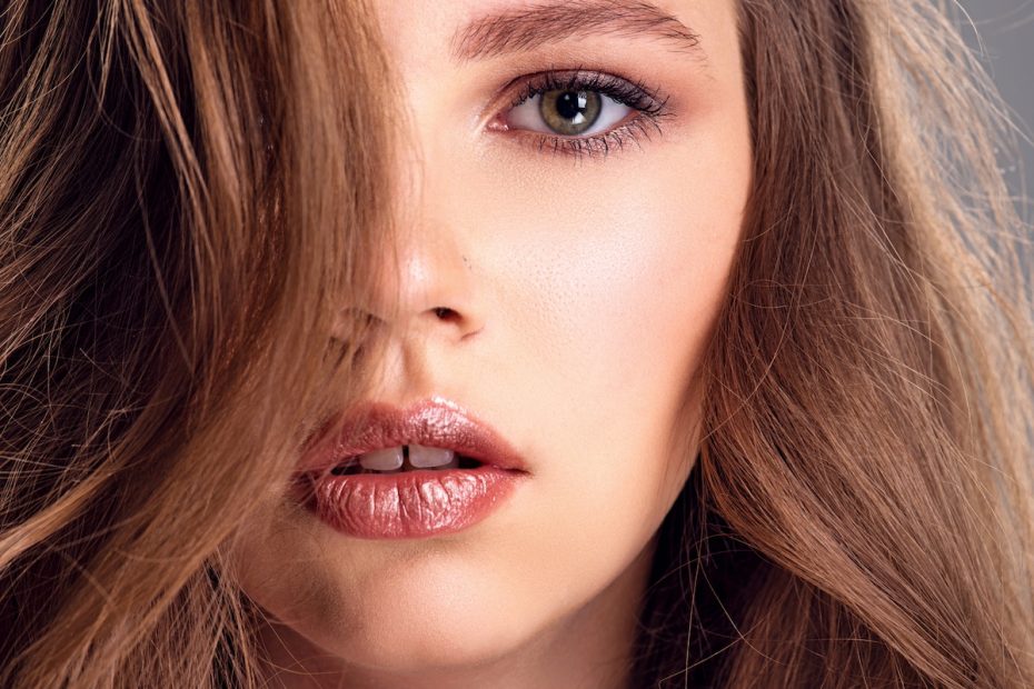 Beautiful Brown Hair Girl With Long Hair. Close Up Of A Pretty Caucasian Girl With Wavy Hair.